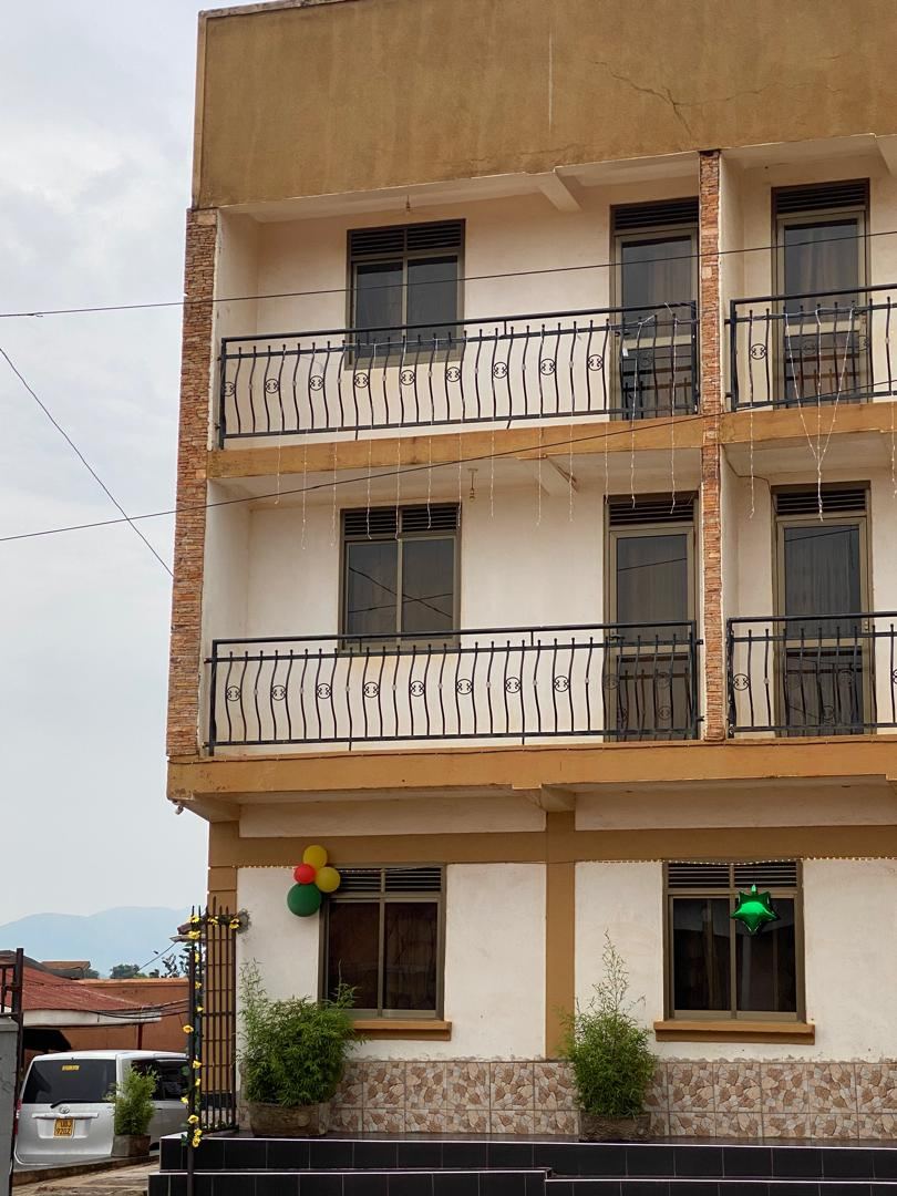 Front of Coronation Hotel Hoima, a cream four-storey building with balconies