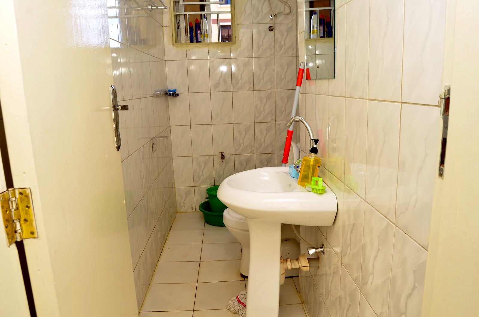 Tiled bathroom with basin and shower