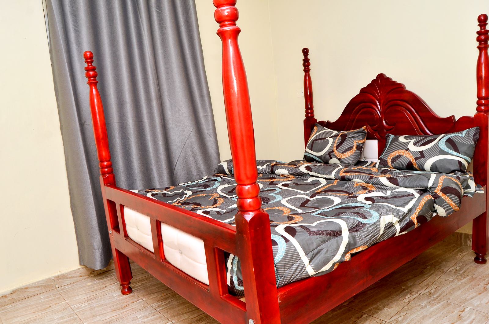 Bedroom with a carved four-poster double bed