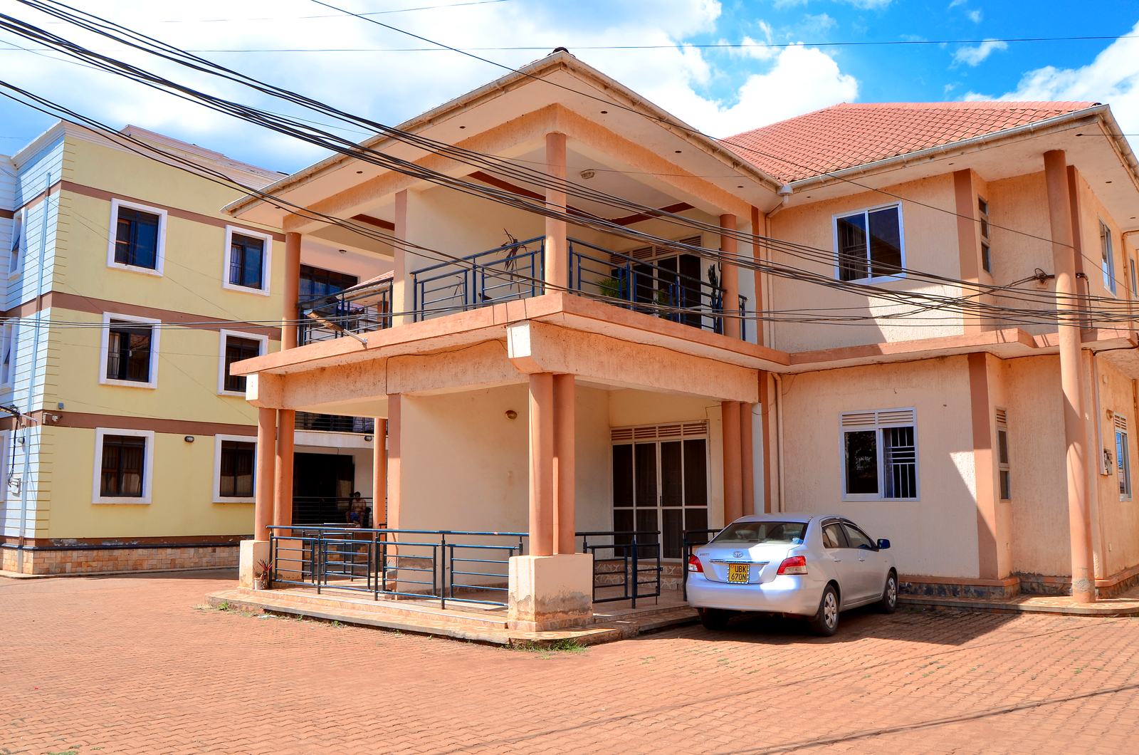 Two-storey apartment building with a parked car