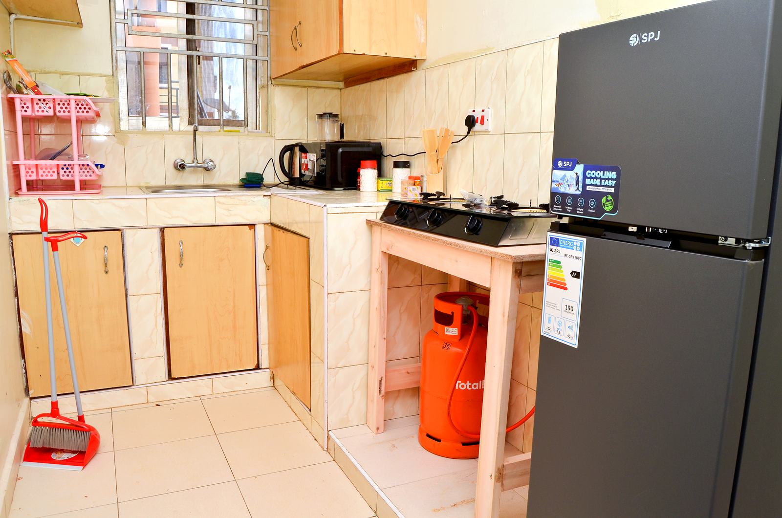 Kitchen with gas cooker, microwave and fridge