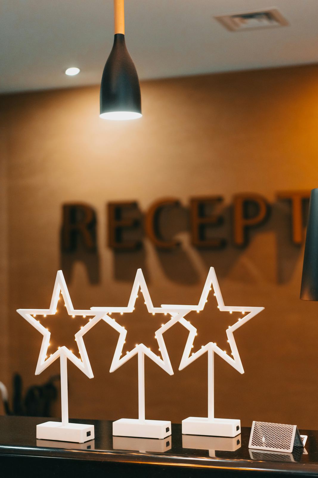 Reception desk with a lit three-star sign