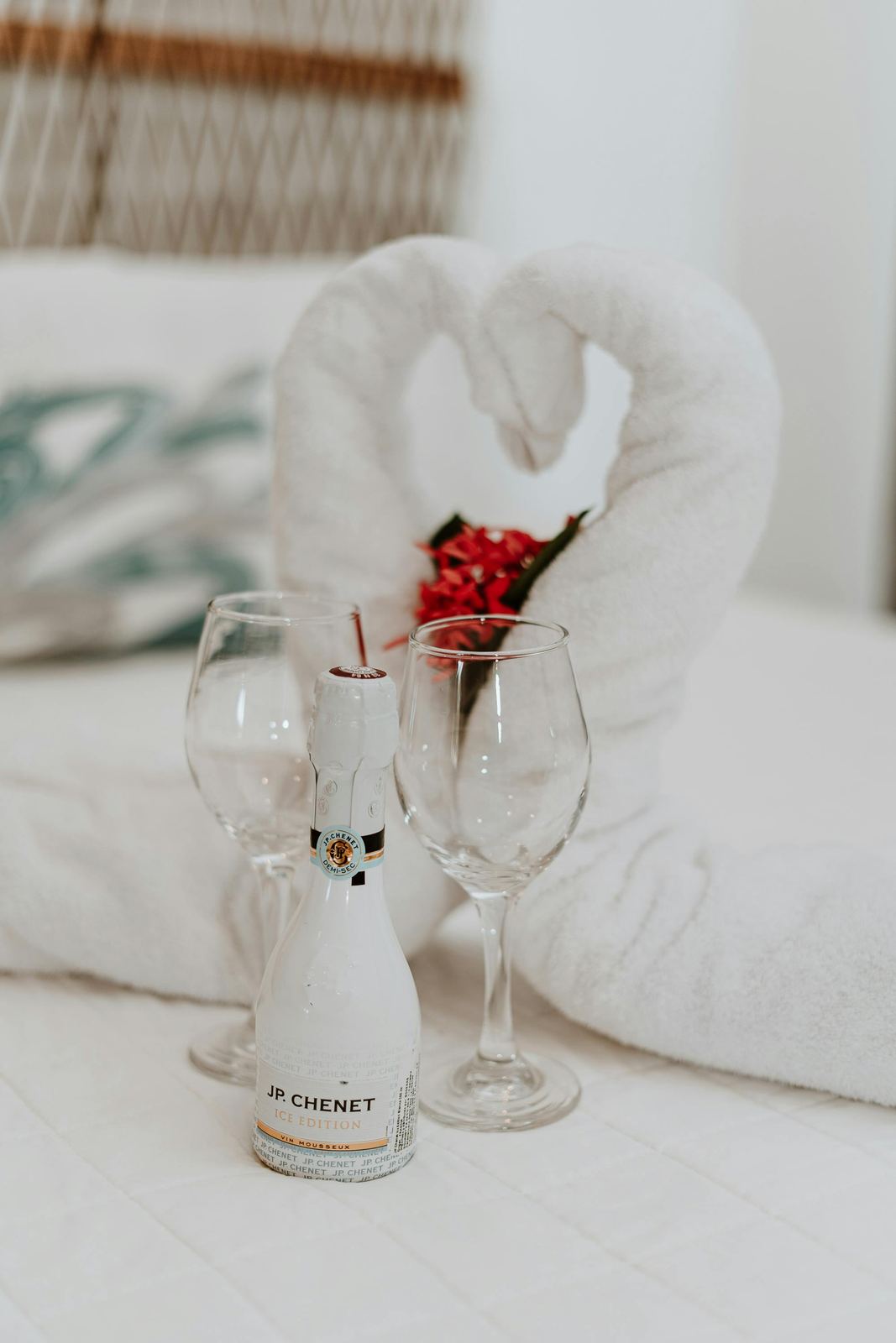 Bed with towels folded into swans and a welcome setup